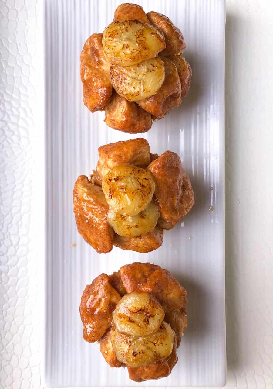 Easy homemade monkey bread muffins! These are mini sized made using biscuit dough, cinnamon and banana pudding! An easy party dessert!