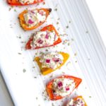 These roasted baby peppers stuffed with feta are a delicious and easy veggie appetizer for any party! I like to make them ahead and serve them cold for a fun finger food and simple crowd pleaser! Bite size and quick to make!