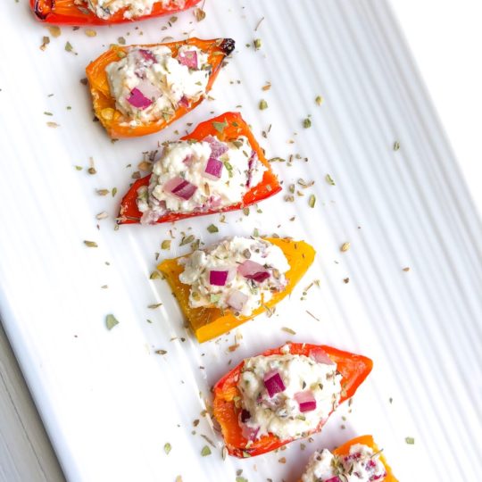 These roasted baby peppers stuffed with feta are a delicious and easy veggie appetizer for any party! I like to make them ahead and serve them cold for a fun finger food and simple crowd pleaser! Bite size and quick to make!