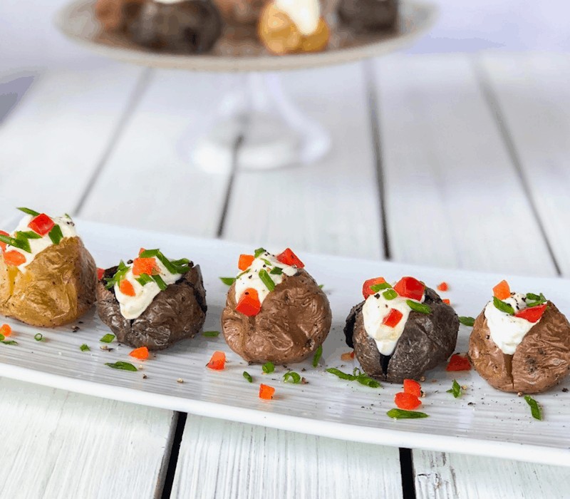 An easy mini potatoes appetizer! Baked red and purple potatoes with a cheesy sour cream filling!