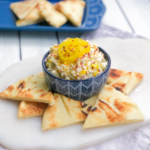 feta cheese dip in a bowl with pita bread