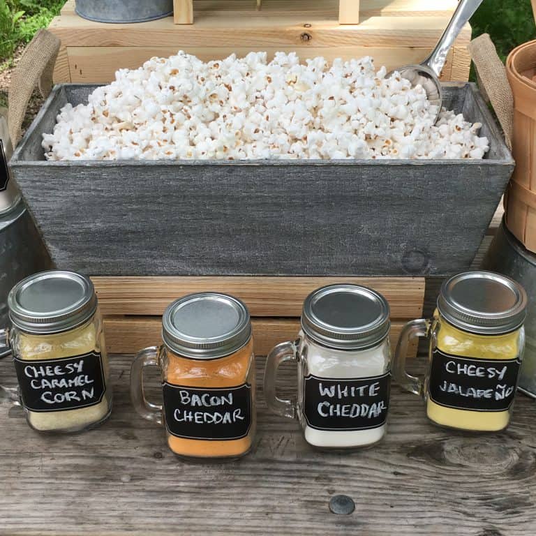 popcorn bar setup with seasonings in mason jars