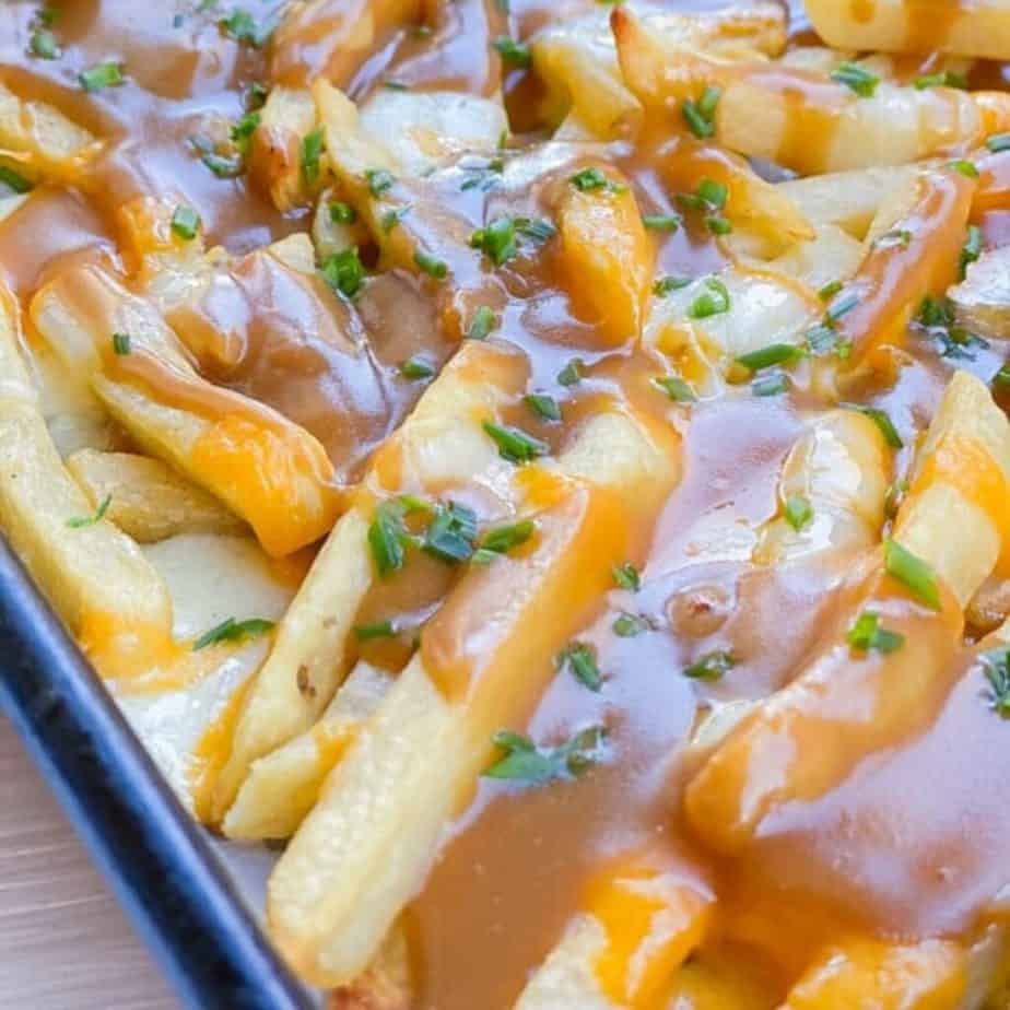 melted mozzarella cheese over top of french fries and gravy