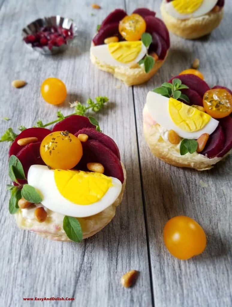 pickle beets and raw egg inside of puff pastry cups
