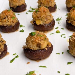 clam stuffed mini mushrooms on a white plate
