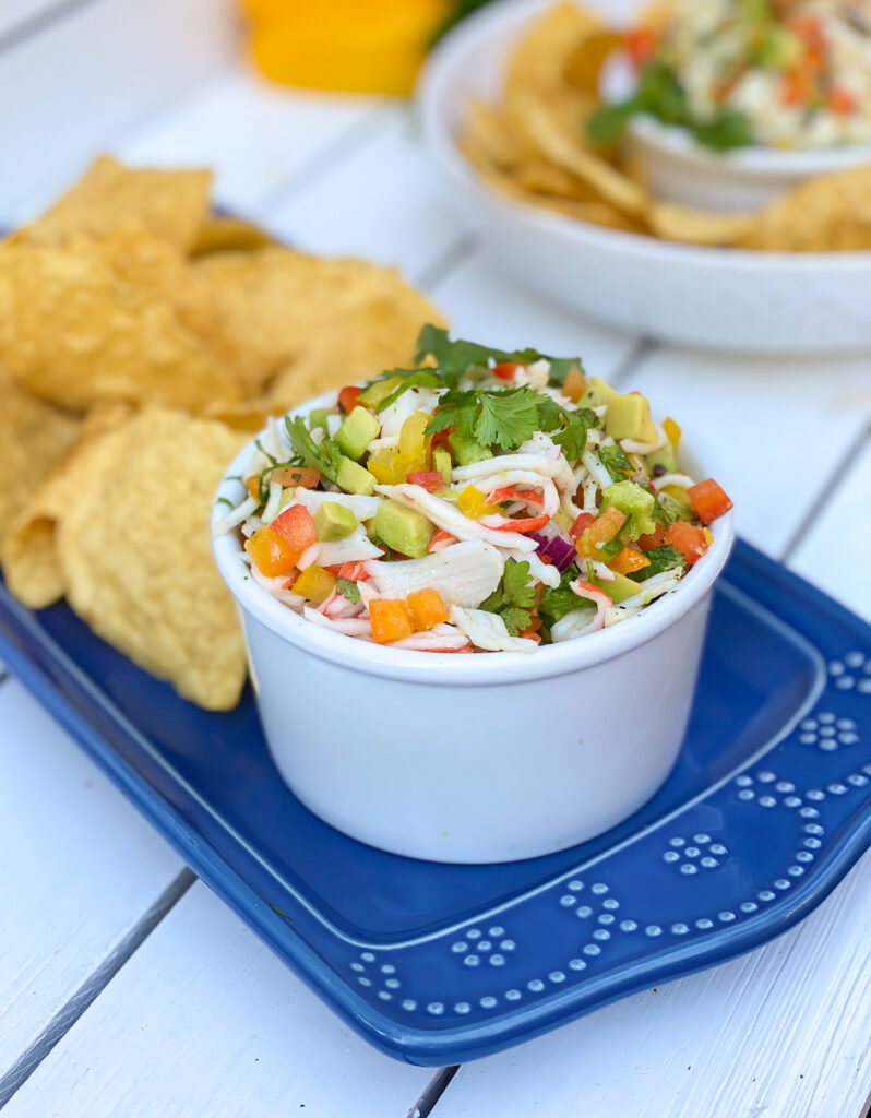 crab avocado peppers onions with tortilla chips on the side