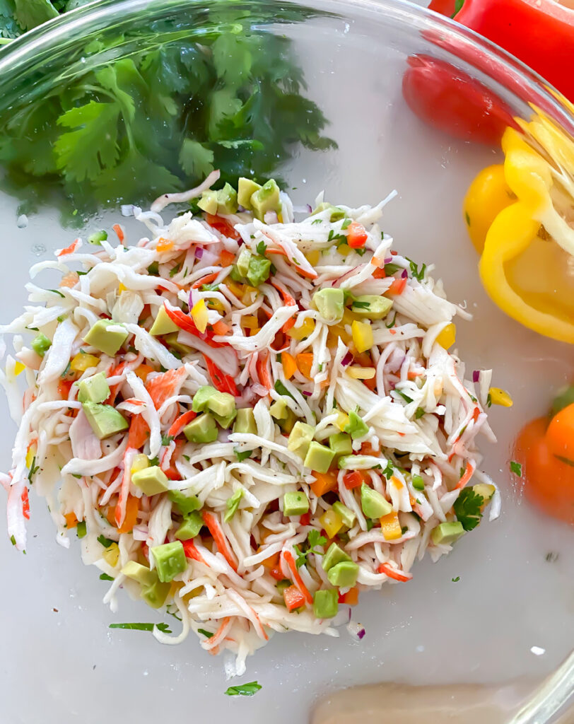 flaked imitation crab meat ceviche in a clear bowl